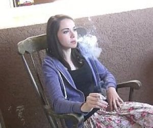 young woman with dark hair  in hiding