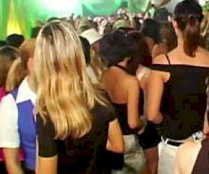 woman with large tits is pleasuring a guy with a hand at a party